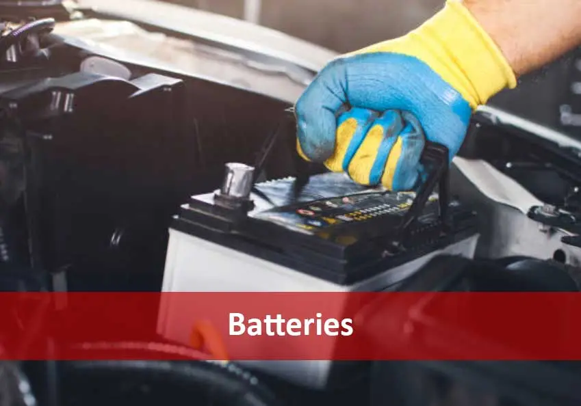 Gloved hand working on a vehicle battery with a red banner reading Batteries