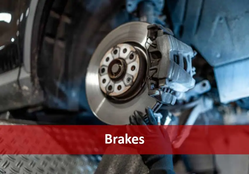 Vehicle brake disc and caliper with a red banner reading Brakes