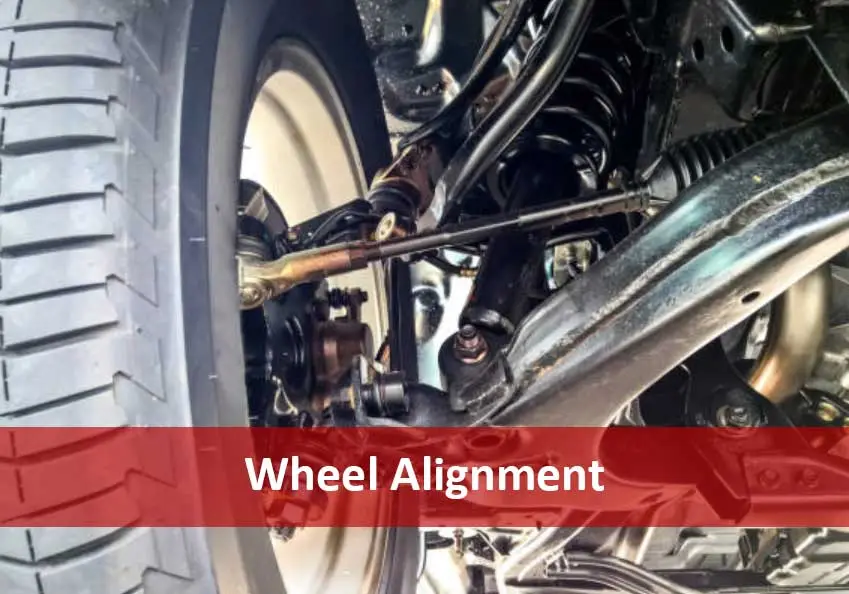 Vehicle wheel and suspension components with a red banner reading Wheel Alignment