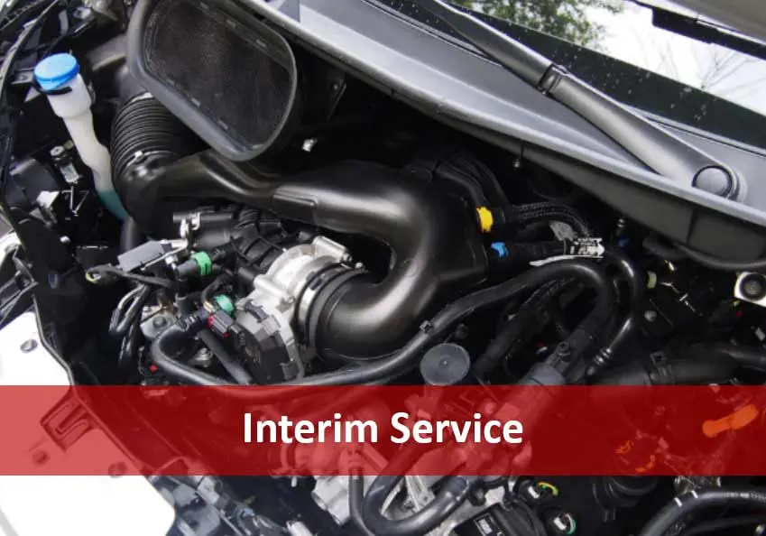 Engine bay with red banner reading Interim Service